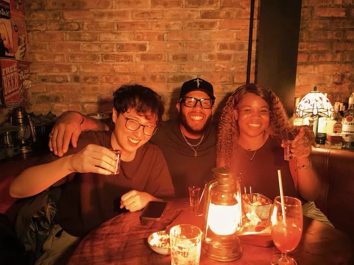 Friends enjoying drinks together around a table at Cheers Pub