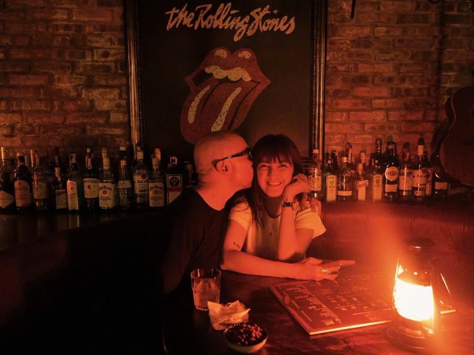 A couple sharing a warm moment at the Cheers bar