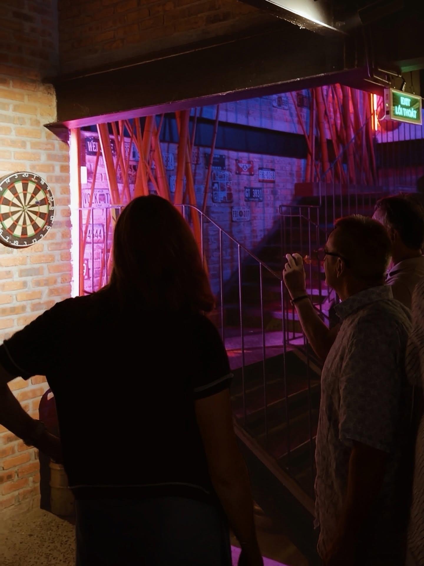 Guests enjoying a game of darts inside Cheers