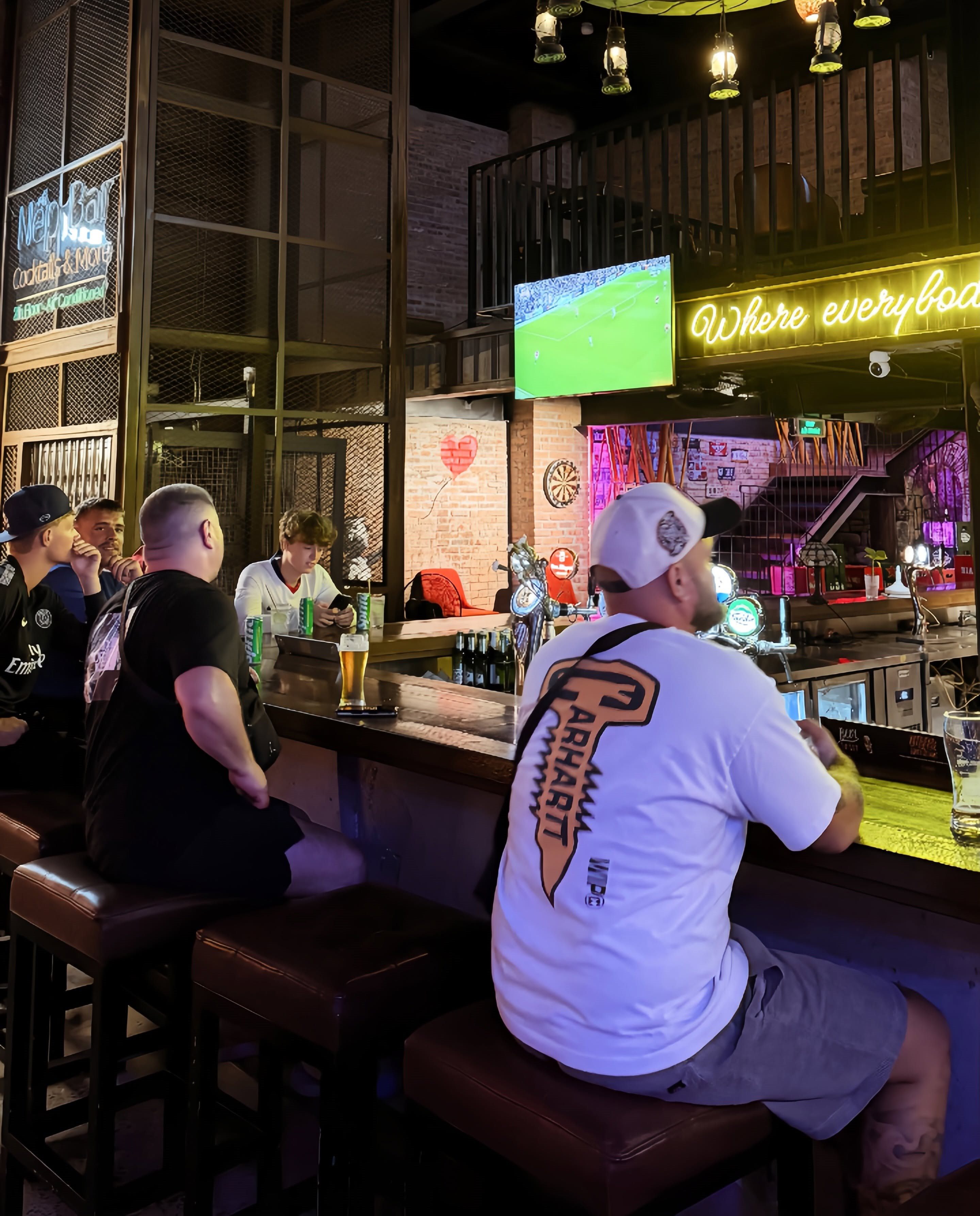 Guests watching live football from the Cheers bar