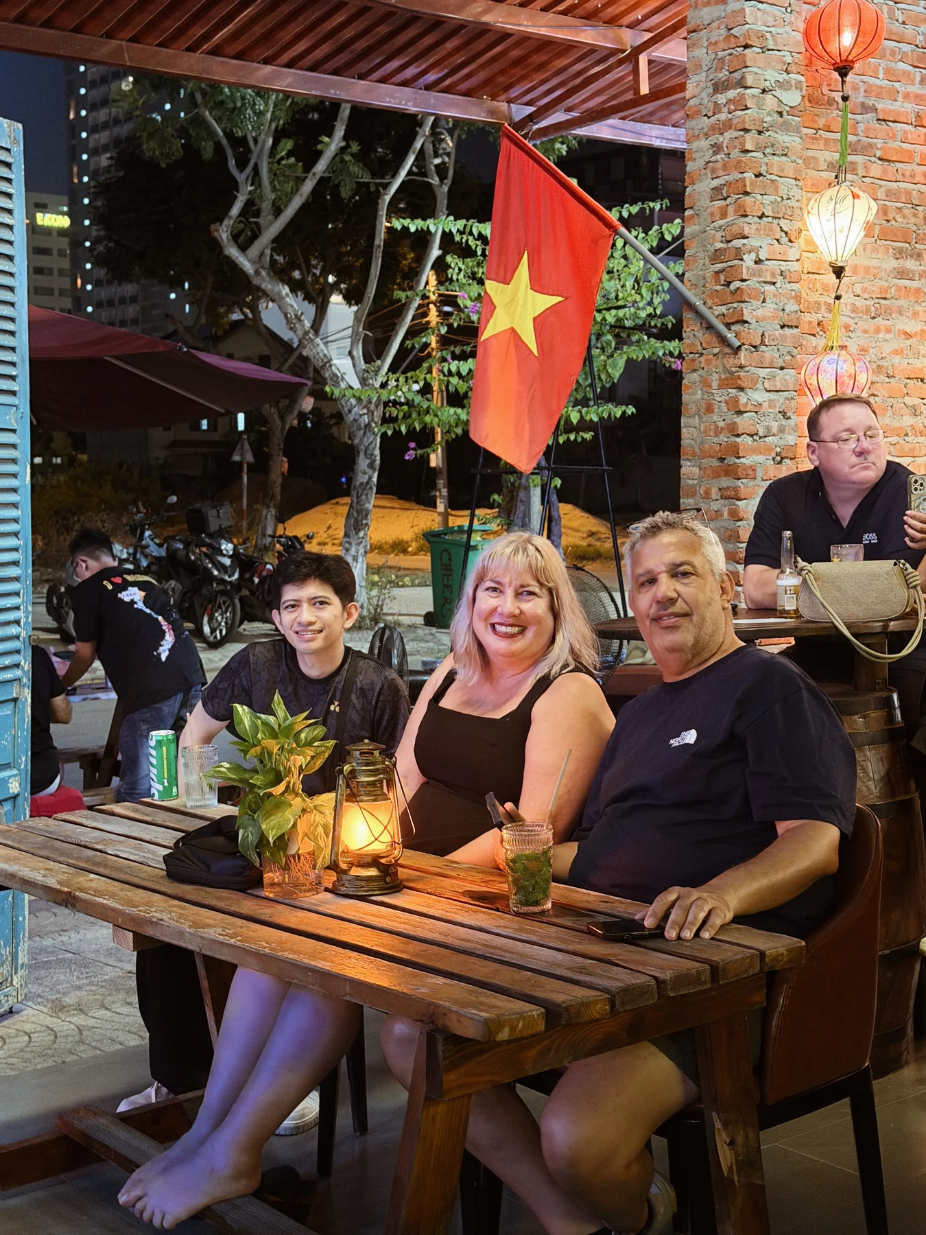 Friends gathered around an outdoor table at Cheers