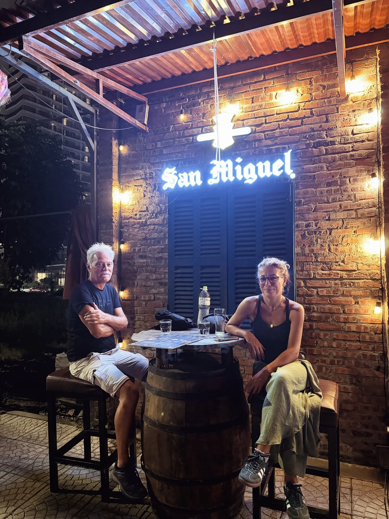 Friends relaxing together near the San Miguel wall at Cheers